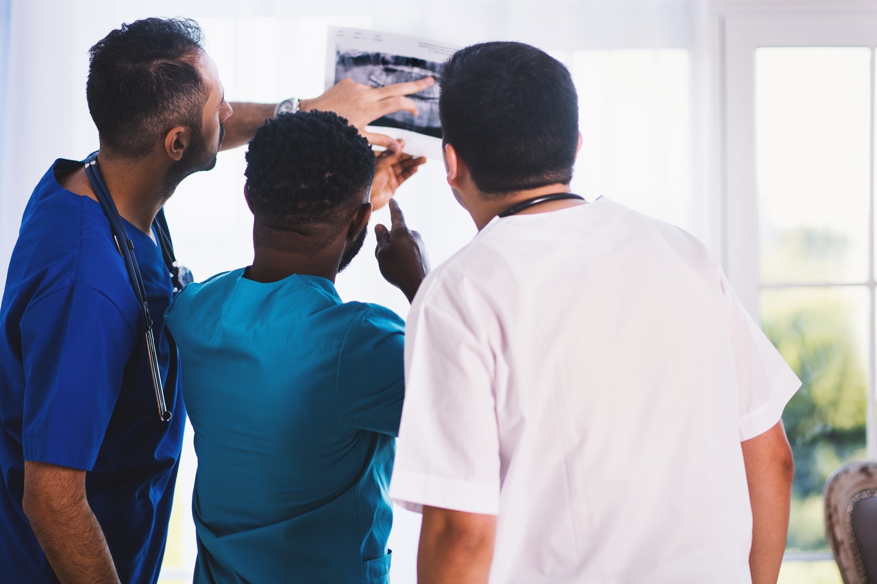 Three medical professionals in a role play.